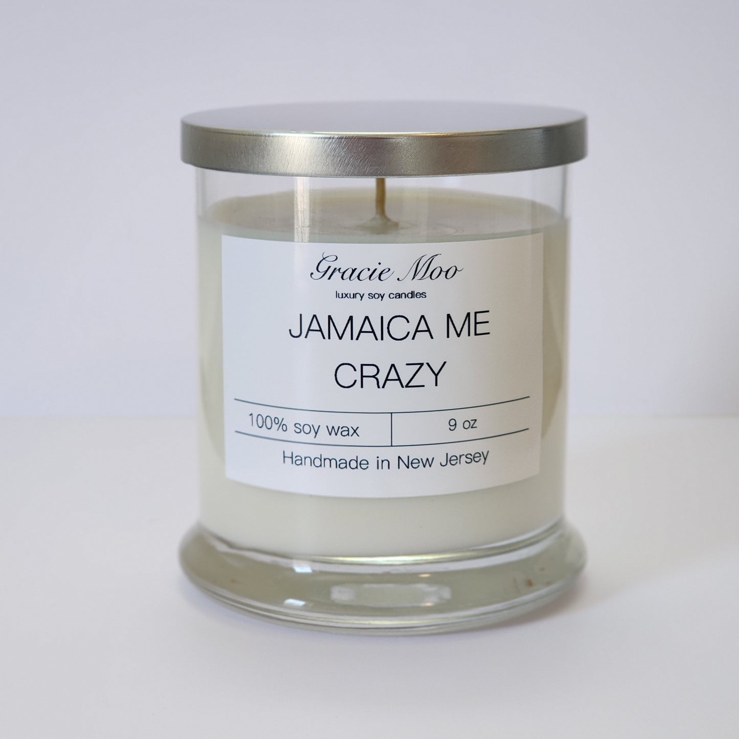Jamaica Me Crazy candle by Gracie Moo Candles, featuring vibrant colors and tropical-inspired design in a glass jar.