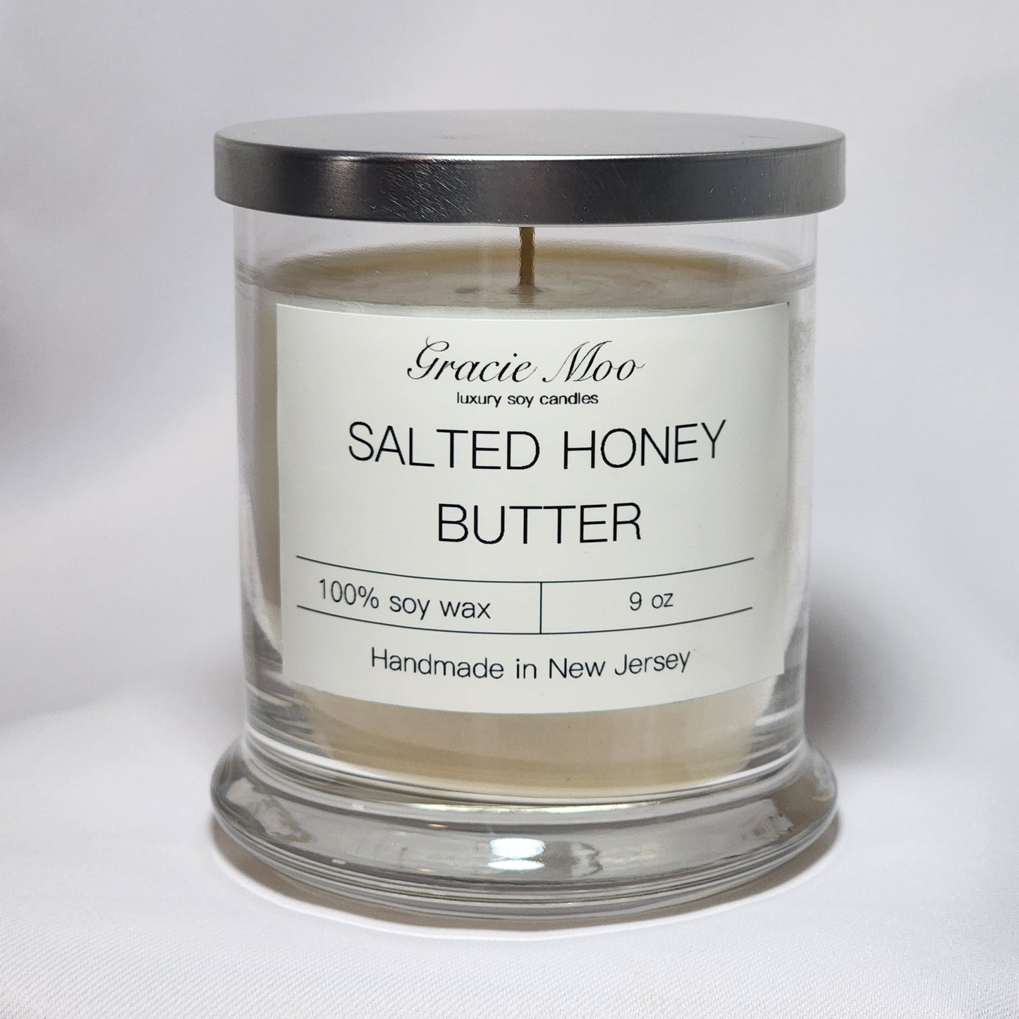 Gracie Moo Candles Salted Honey Butter candle in a glass jar with a warm, inviting glow and rustic label design.