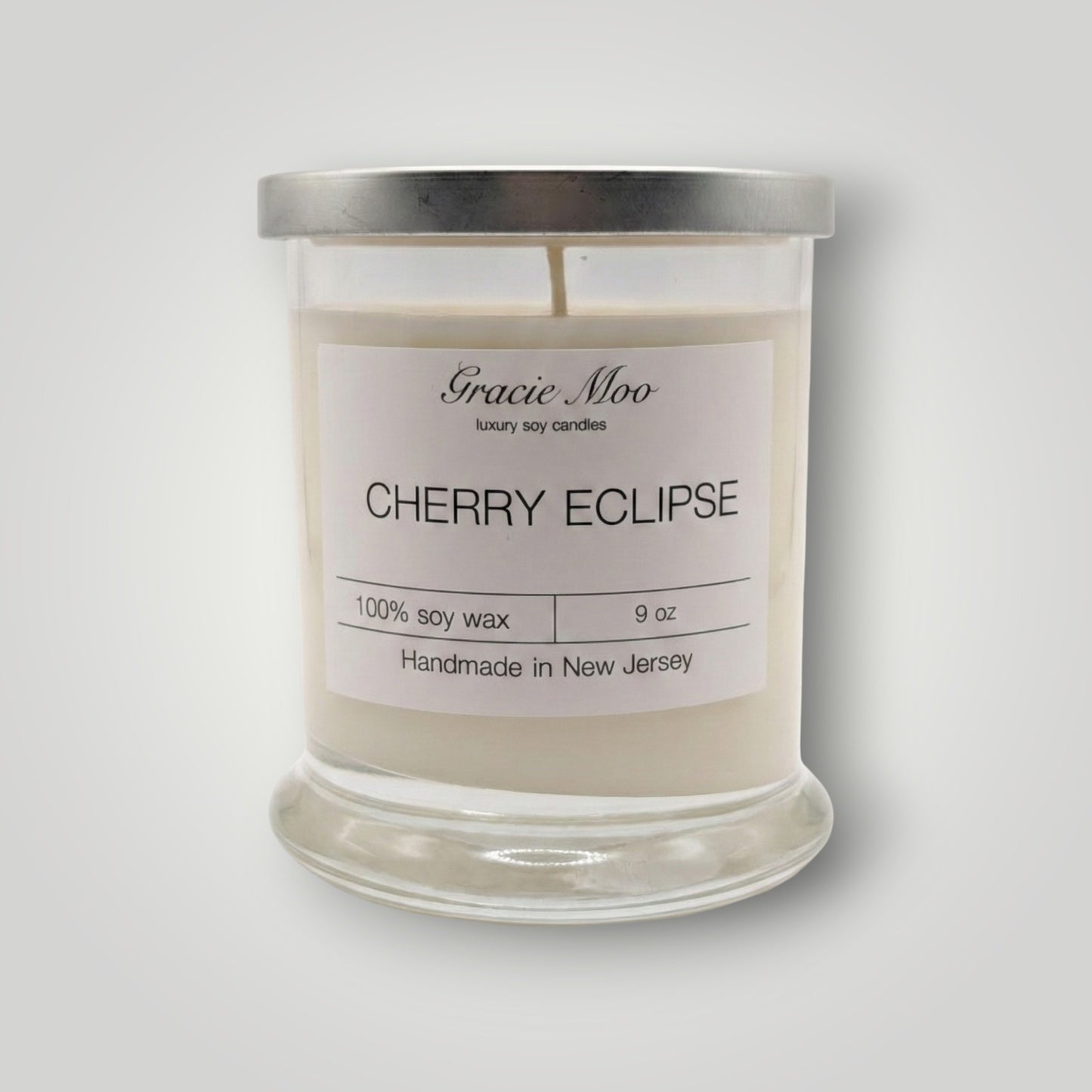 Cherry Eclipse Status candle by Gracie Moo Candles with a sleek black and red design, perfect for ambient lighting.
