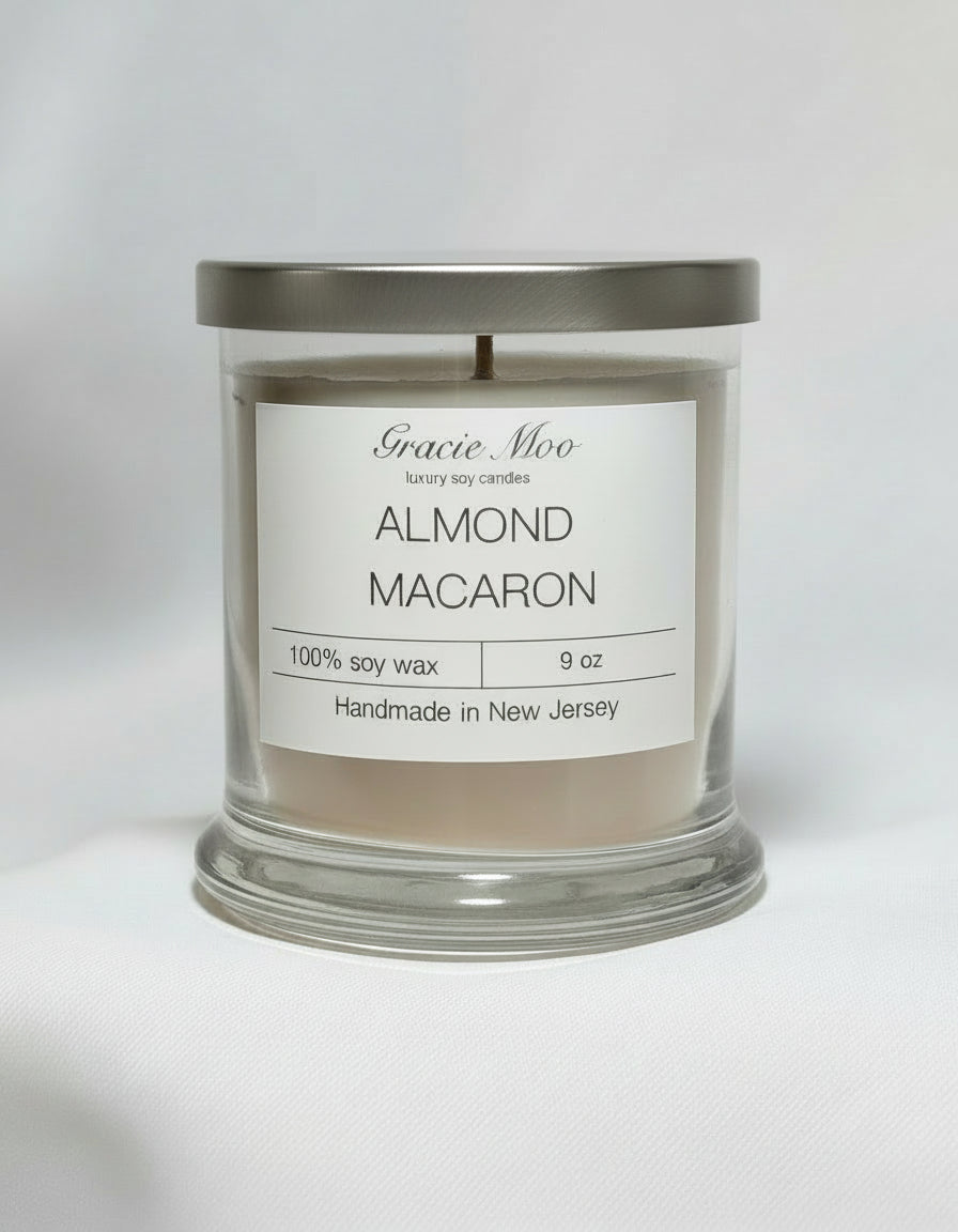 Almond Macaron candle by Gracie Moo Candles, featuring a decorative design and vibrant color in a sleek glass container.
