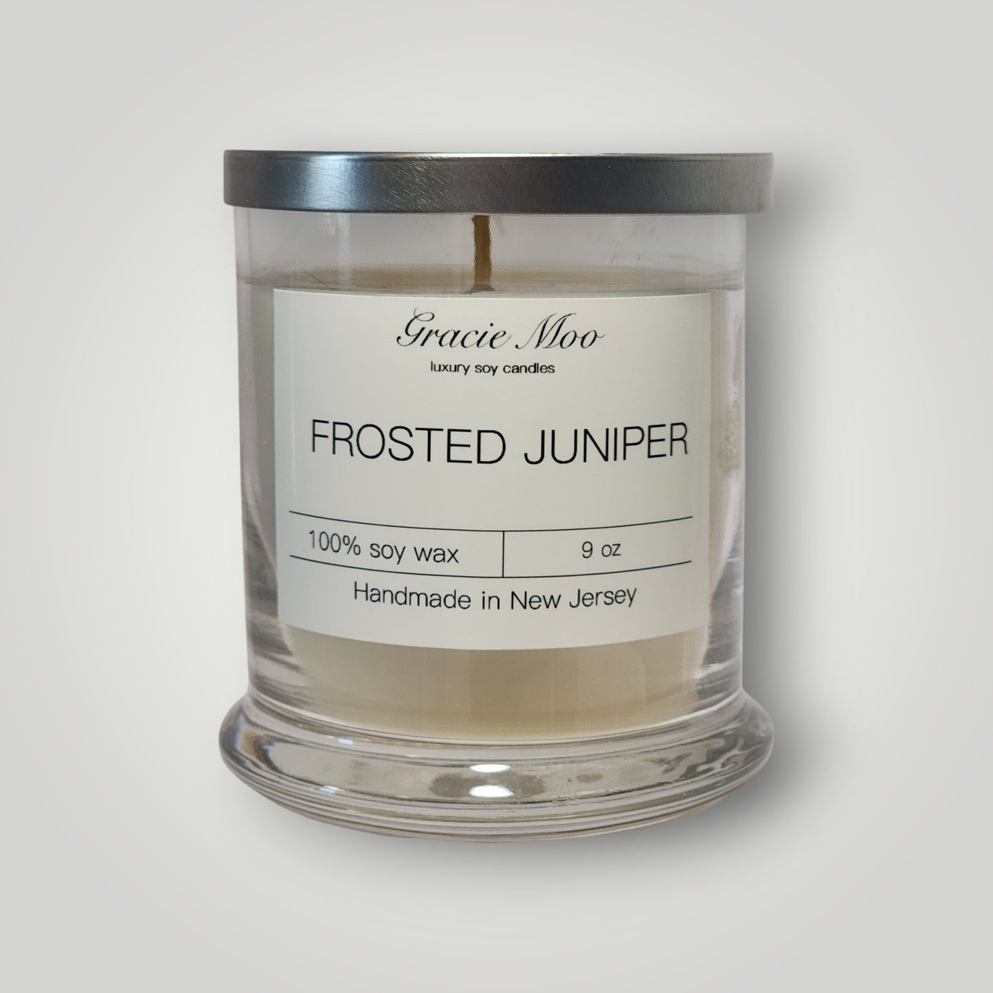 Frosted Juniper Status Candle by Gracie Moo Candles featuring a frosted glass candle with juniper design.