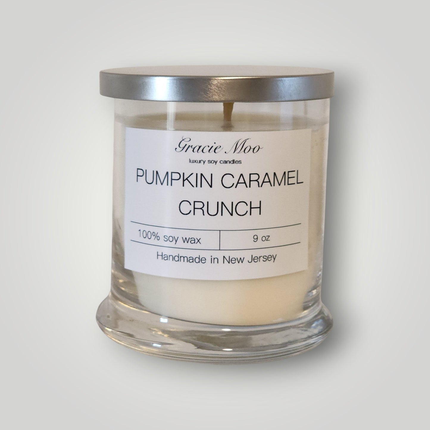 Pumpkin Caramel Crunch Status Candle by Gracie Moo Candles, featuring a warm orange hue and a textured surface.