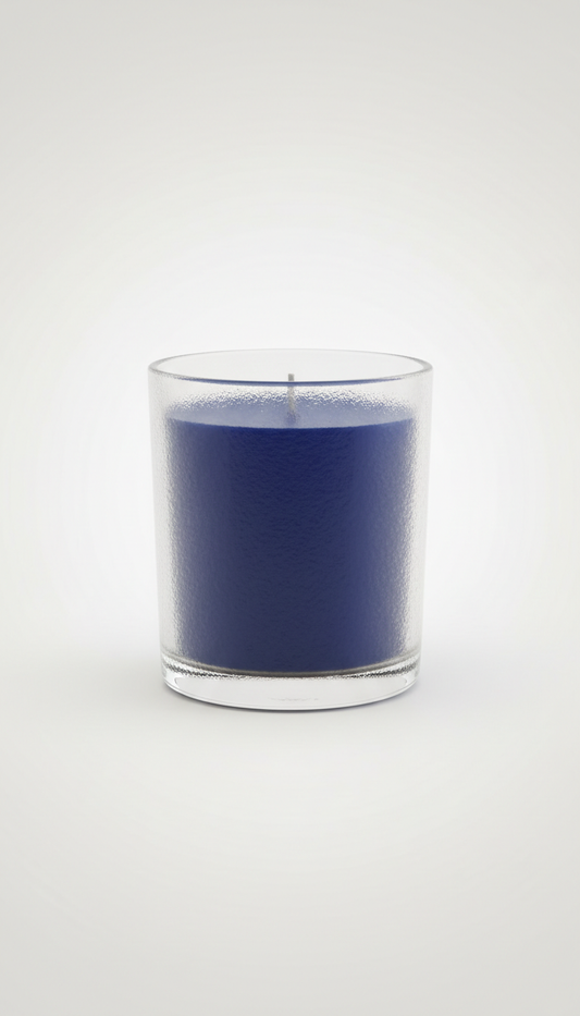 Gracie Moo Candles decorative candle with floral design in a glass jar, showcasing warm amber glow and intricate pattern.