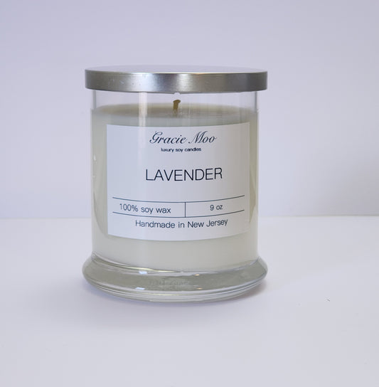 Lavender Status Candle by Gracie Moo Candles featuring a calming lavender hue and elegant glass container.