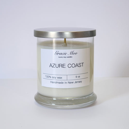 Azure Coast Status Candle by Gracie Moo Candles, featuring a calming blue hue and a stylish container design.