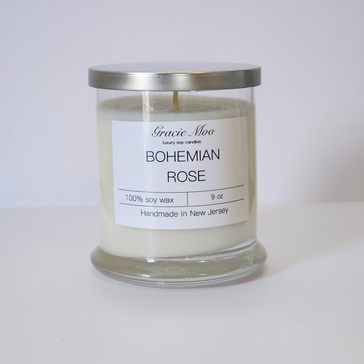 Bohemian Rose Status Candle by Gracie Moo Candles with intricate floral design and soft, warm glow.