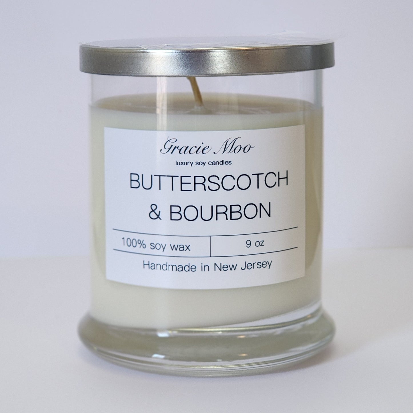 Butterscotch & Bourbon candle by Gracie Moo Candles in a stylish glass jar with warm, inviting colors.