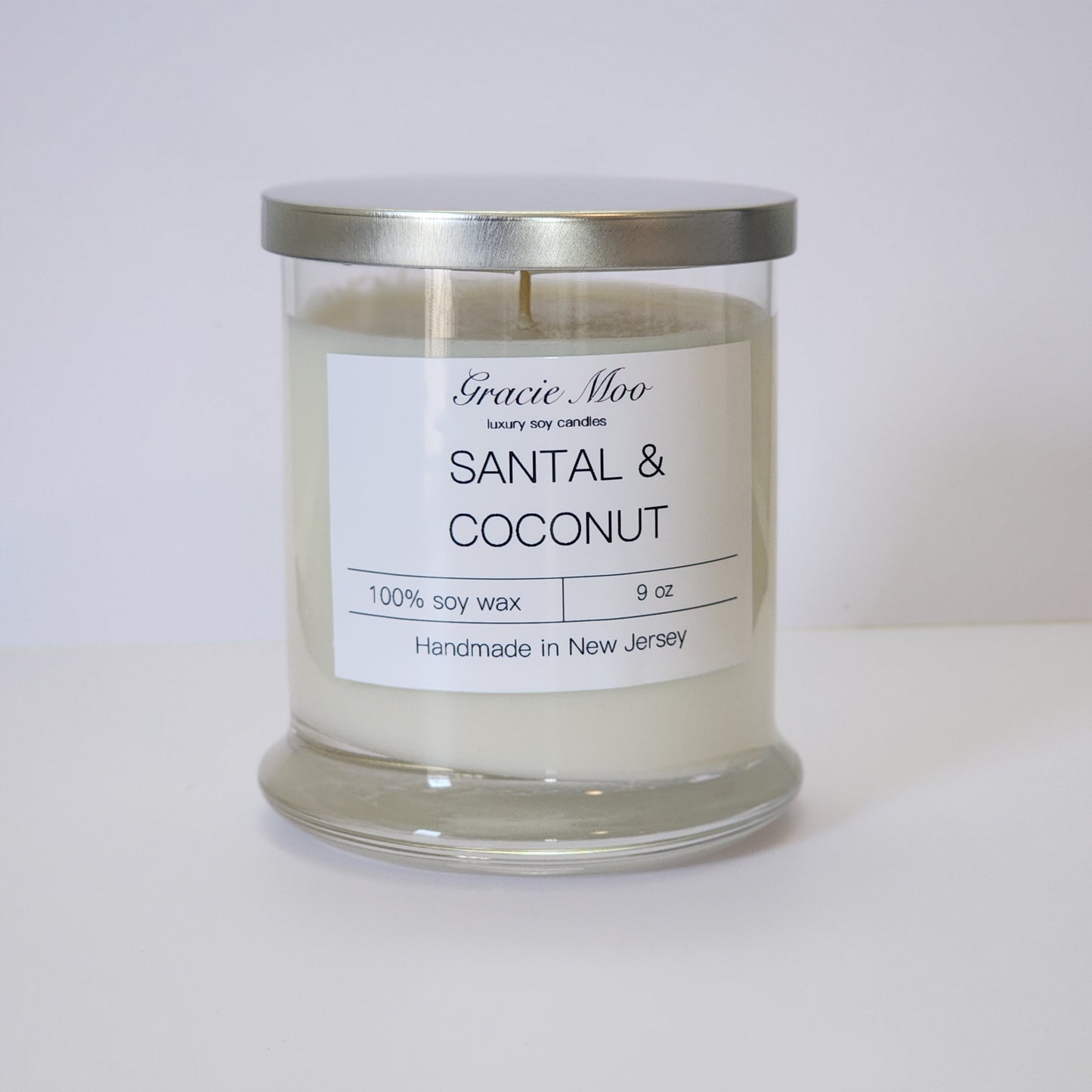 Santal & Coconut candle by Gracie Moo Candles, featuring a warm glow and a minimalist design in a glass jar.