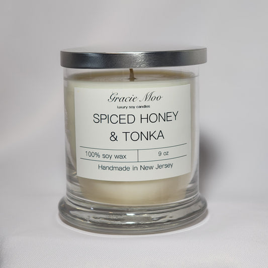 Spiced Honey & Tonka candle by Gracie Moo Candles, showcasing a warm glow with a rustic design in a glass jar.