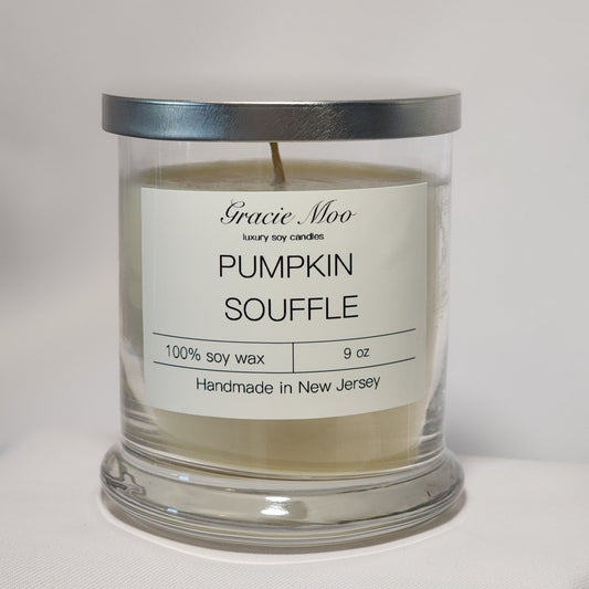 Pumpkin Soufflé candle by Gracie Moo Candles, featuring a warm orange hue and a classic glass container.