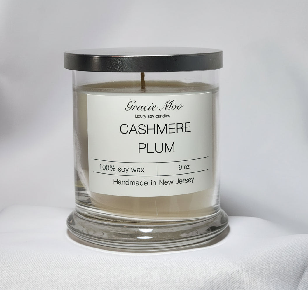 Gracie Moo Candles Cashmere Plum Status Candle with a rich plum color and elegant glass container.