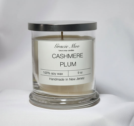 Gracie Moo Candles Cashmere Plum Status Candle with a rich plum color and elegant glass container.
