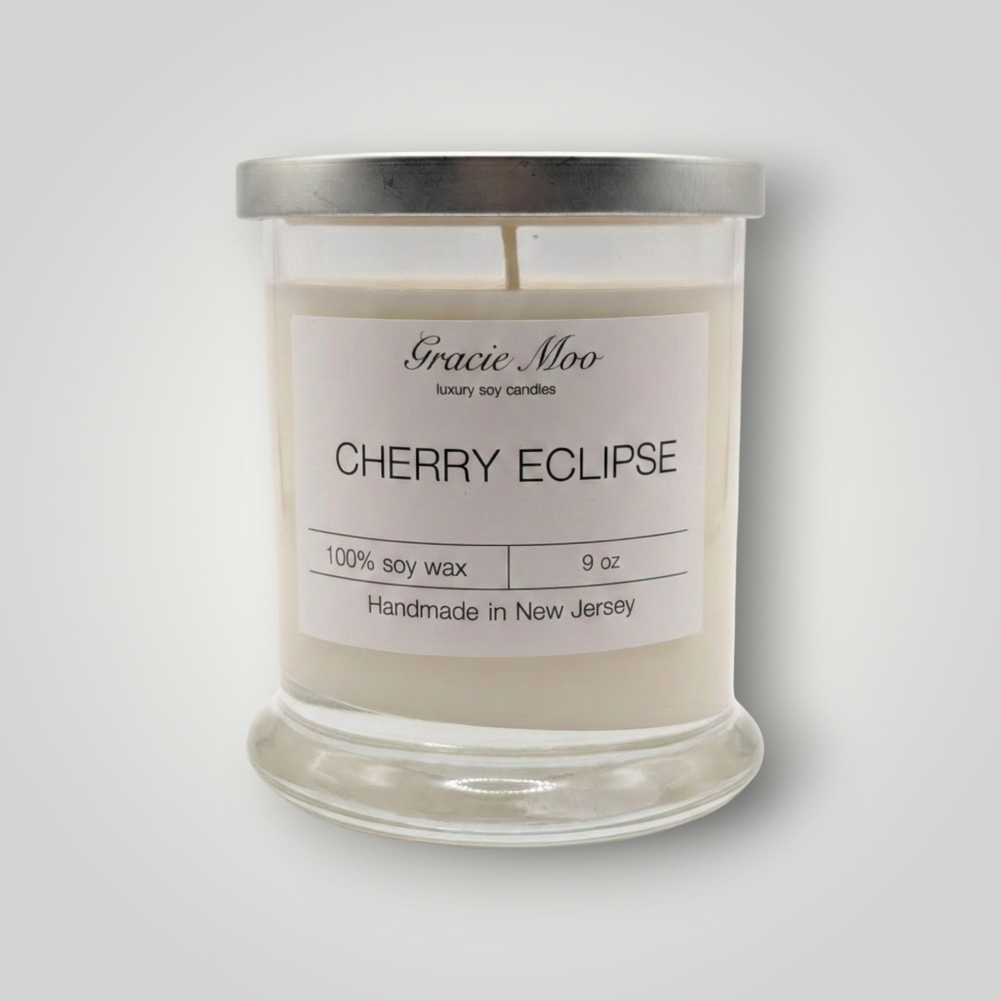 Cherry Eclipse Status candle by Gracie Moo Candles with a sleek black and red design, perfect for ambient lighting.