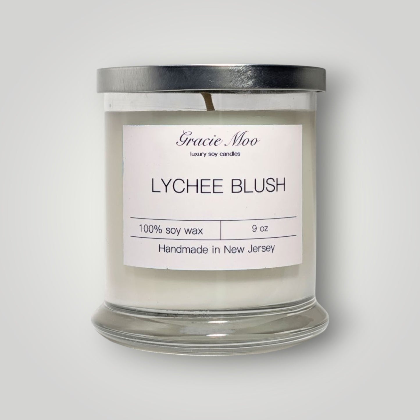 Lychee Blush Status Candle by Gracie Moo Candles featuring a soft pink wax with a natural cotton wick.