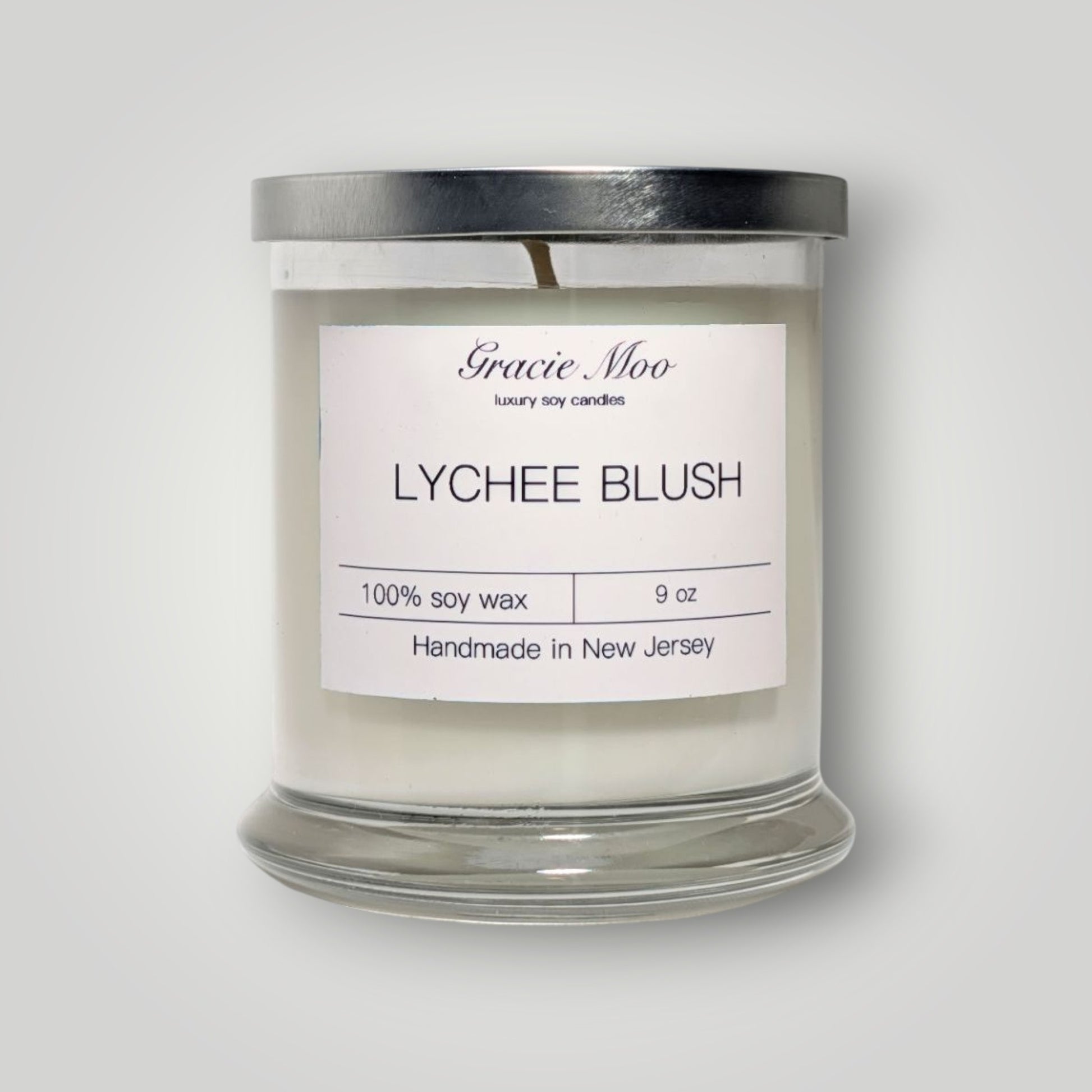 Lychee Blush Status Candle by Gracie Moo Candles featuring a soft pink wax with a natural cotton wick.