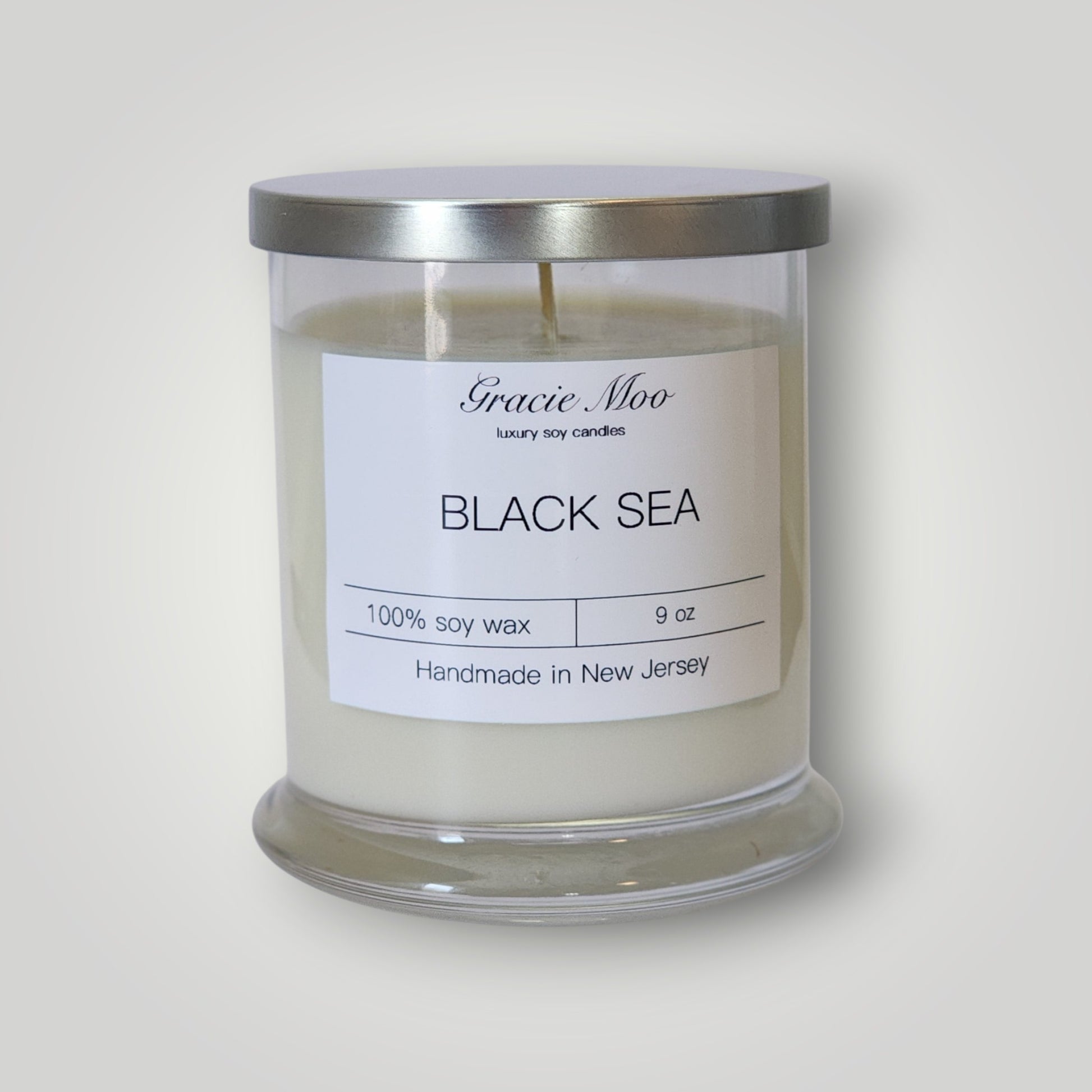 Black Sea Status Candle by Gracie Moo Candles featuring a sleek black design and elegant wax finish.
