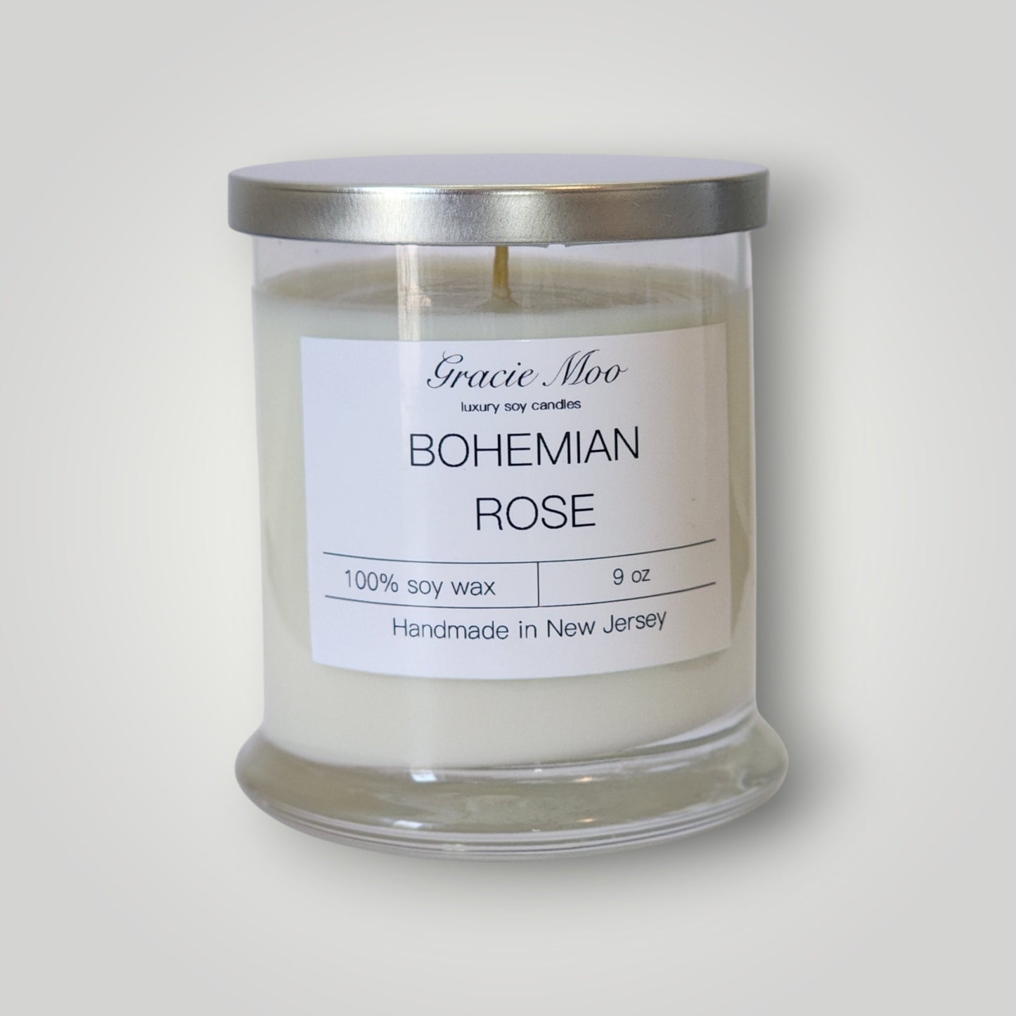 Bohemian Rose scented candle by Gracie Moo Candles with a decorative floral design on the candle holder.